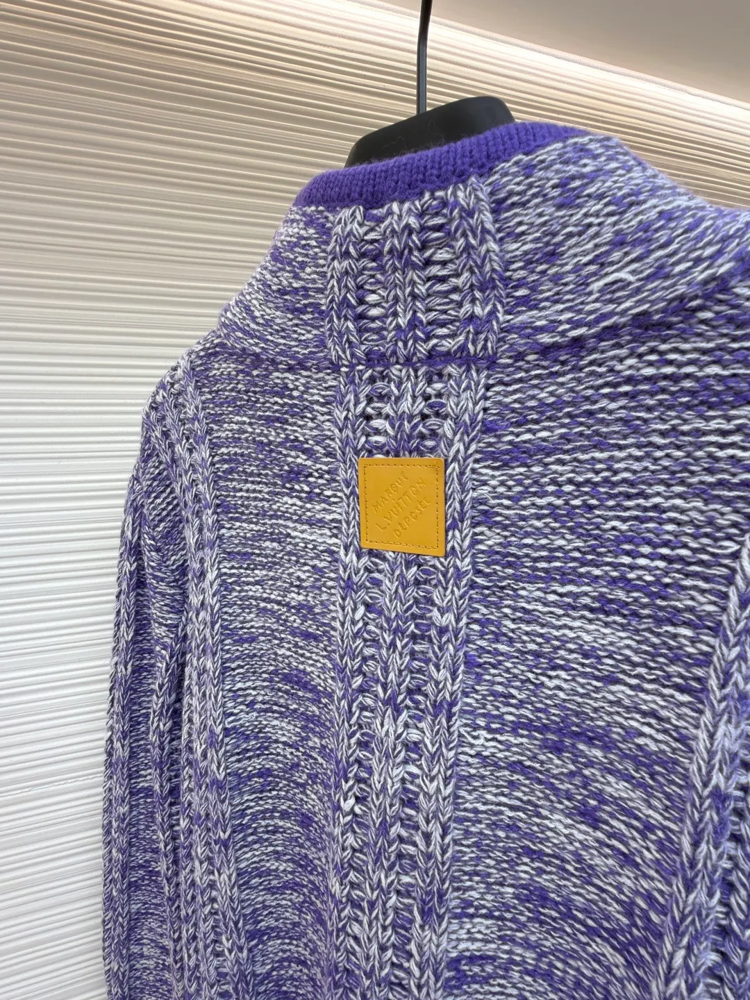 LOUIS VUITTON letter badge half-zip pullover tassel sweater ●Original version: purchased and developed at 20700 ●Item number: 1682315-C05 ●Fabric: wool fabric ●Technology: tassel knitting ●Color: purple ●Version: fitted version ●Weight: about 870 grams ●Size: S-M-L-XL ●Description: This half-zip sweater is made of colorful dot blended wool yarn, which is blended and dyed with dark purple, light purple and off-white yarns. It uses multiple twisting processes to create a mottled snowflake texture effect. The yarn has both softness and crispness. The body of the garment adopts vertical pit weaving technology, and the spacing and depth of the pits are controlled by a computerized flat knitting machine to form a three-dimensional longitudinal texture, which not only modifies the body shape but also enhances the breathability of the clothing. The half-high collar is spliced ​​with solid-color ribbed fabric and matched with a customized metal zipper. The zipper teeth are gold-plated and polished, which makes the pull smooth and not easy to oxidize. The hem adopts hand-made tassel technology. The yarn is cut to a fixed length and then combed out. The tassels hang naturally without knotting. The sides and cuffs of the garment are densely overlocked to effectively prevent threading. Every craft detail takes into account both design beauty and practicality. The overall wiring is straight and delicate, the fabric is comfortable and soft, and the color is consistent without color difference. It can be matched with the same style to create a fashionable look and control various occasions. Customized accessories, complete with three standards, same style for men and women!